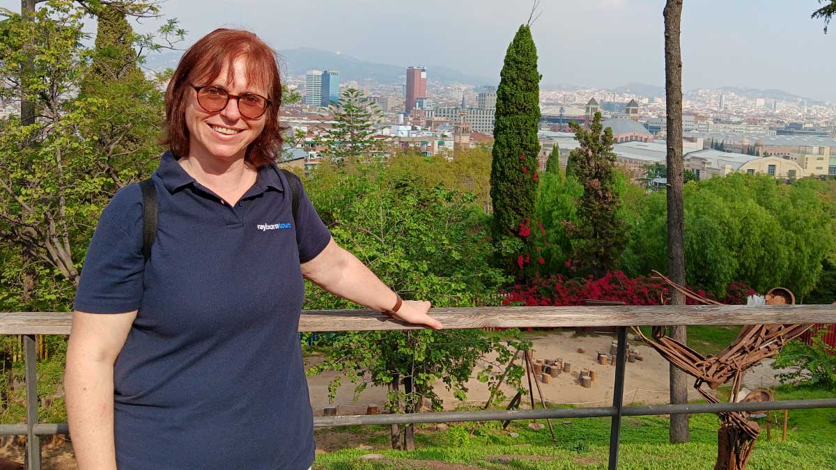 Tour Manager, Lucy Elliot, poses for the camera with Barcelona behind her in the distant