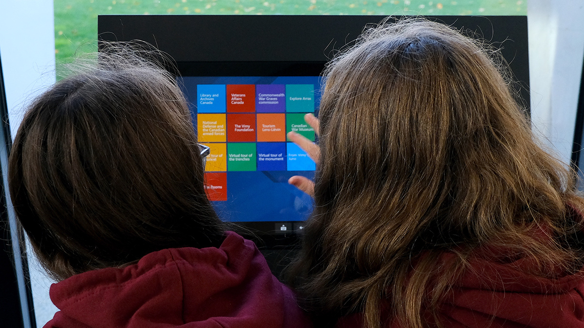 History students interact with a computer screen.