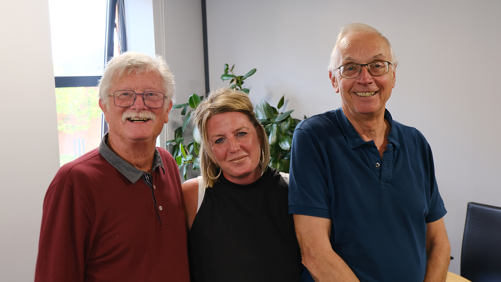 History Tour Guides Trevor Booker and Tony Smith stand either side of Nicola Astle, Rayburn Tours Marketing Manager, and pose for the camera