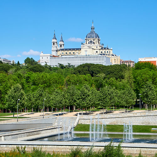 Green spaces of Madrid Rio at spring day with the Almudena Cathedral in background. Madrid, Spain. 