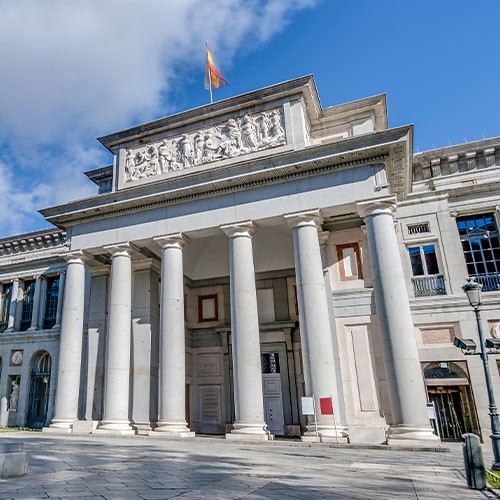 Prado Museum facade and Cervantes statue in Madrid, Spain 