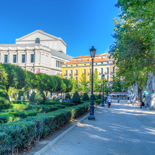 Beautiful view on the Royal Theatre (Teatro Real) from the Plaza de Oriente on the blue sky background with white clouds in Madrid 
