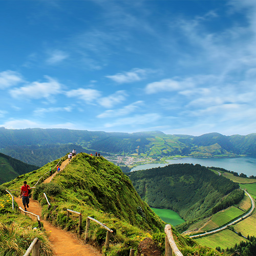People walk around the trails of Sete Cidades in the Azores.