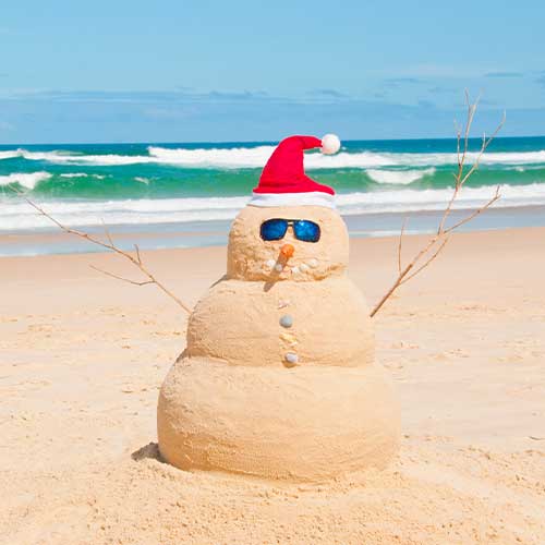 Snowman on summer holidays made out of sand instead of snow