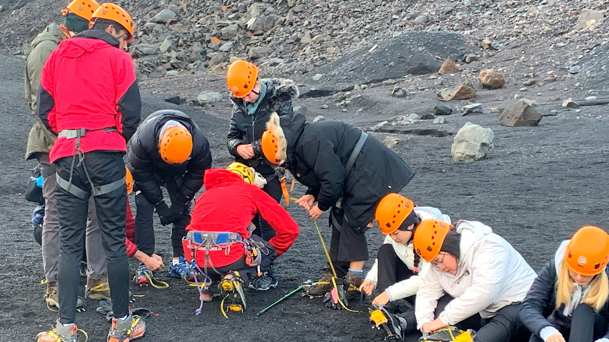 Students on black sand sorting calmpon shoes