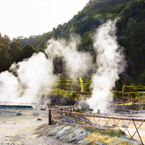 Steam rises from hot springs of Lagoa das Furnas Fumaroles.