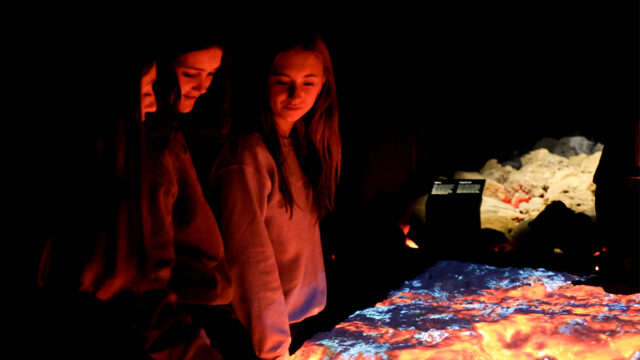 Students engage with an exhibit in the Lava Centre in Iceland