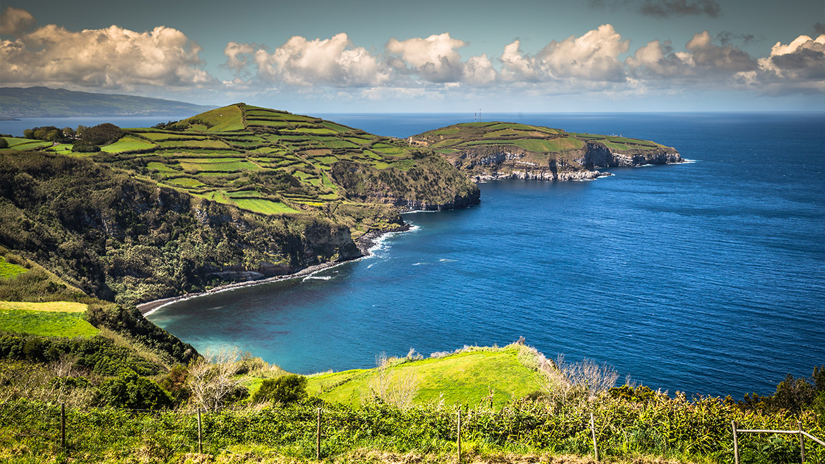 Vibrant blue Atlantic waters and lush green coastal landscapes of the Azores.