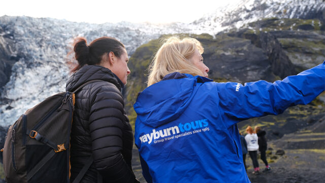 Val Vannet, Field Study Tutor for Rayburn Tours, speaks with a student at a glacier.