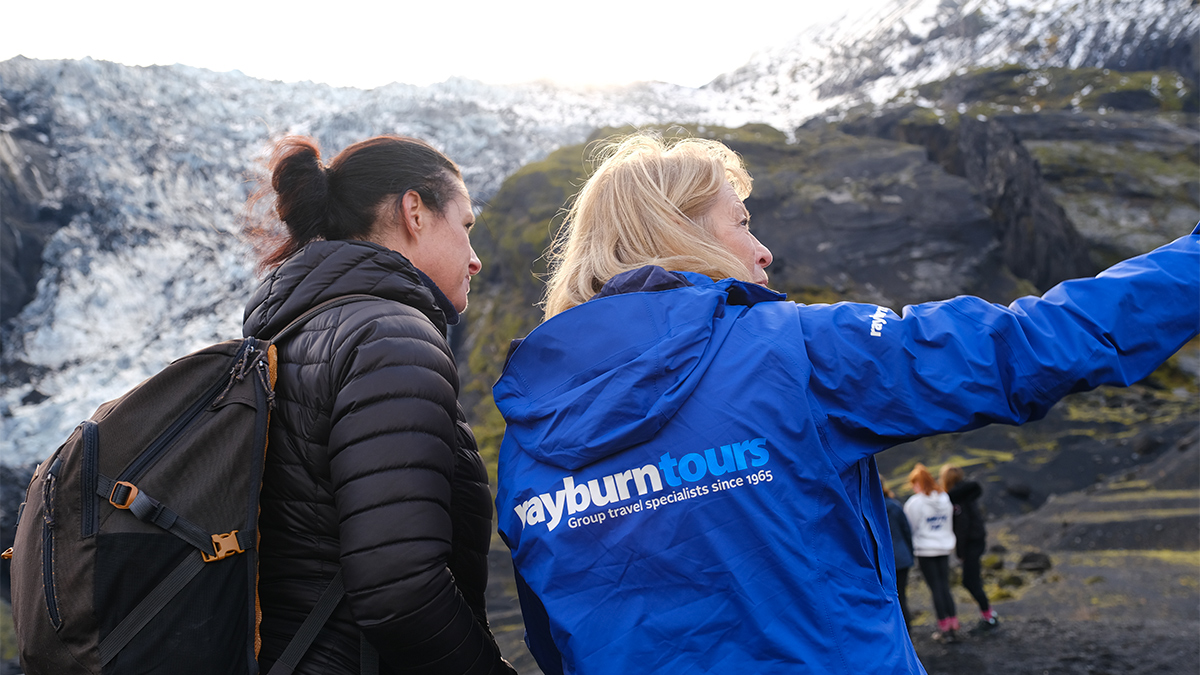 Val Vannet, Field Study Tutor for Rayburn Tours, speaks with a student at a glacier.