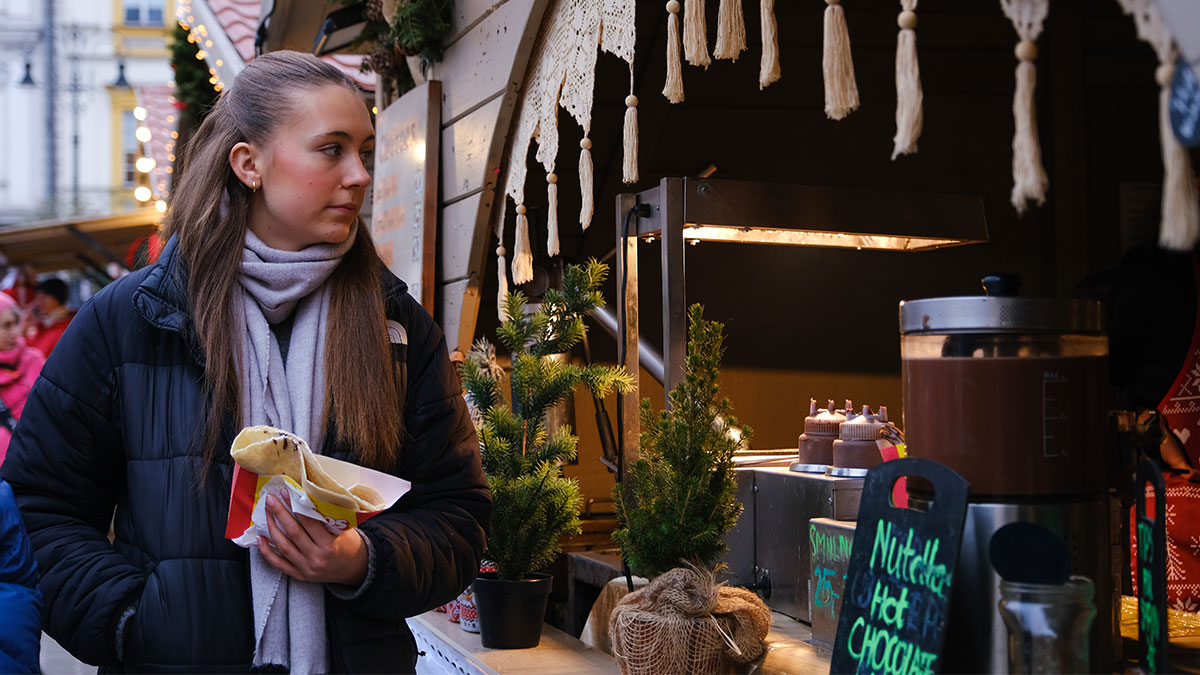 Student shopping at the Christmas market in Krakow