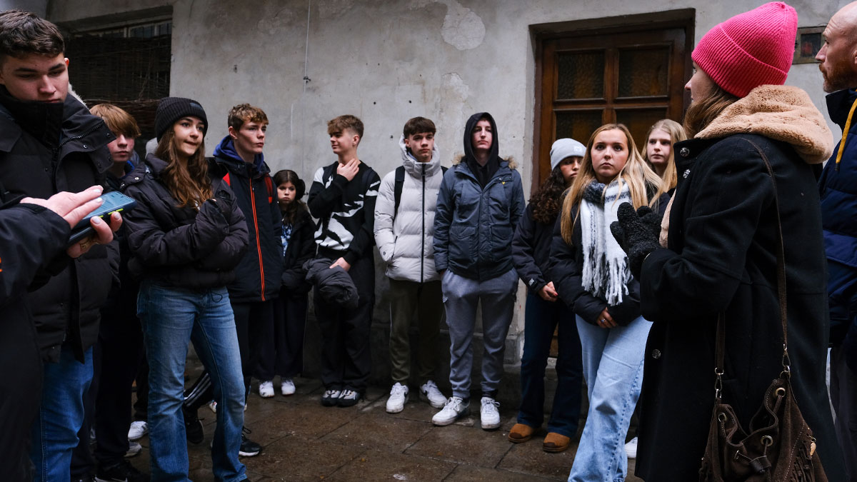 School group on a walking tour of Krakow with a tour guide