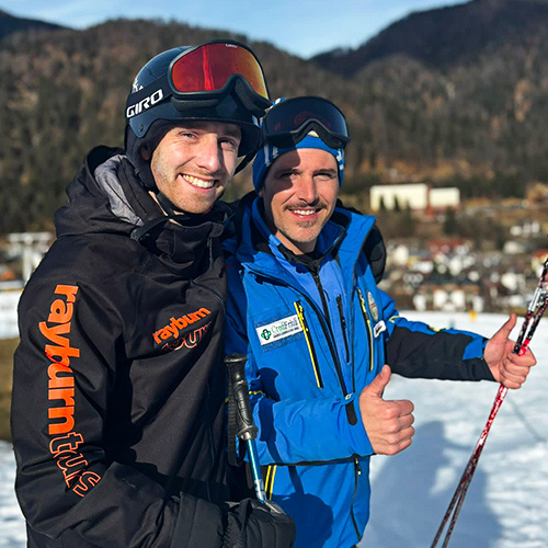 Rayburn Tours Ski Rep poses arm-in-arm with resort staff whilst visiting that ski destination.