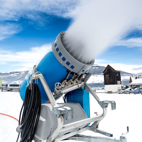 Big snow cannon making artificial snow on ski slope