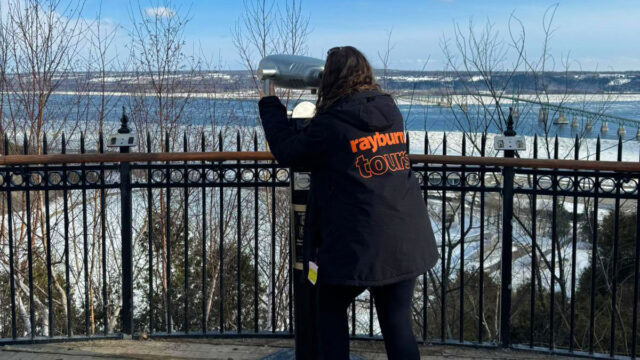 Rayburn Tours Ski Rep Annabelle Nojac overlooks Montmorency Falls, via binoculars, in Canada