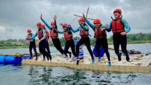 Students jumping from a raft and into the water