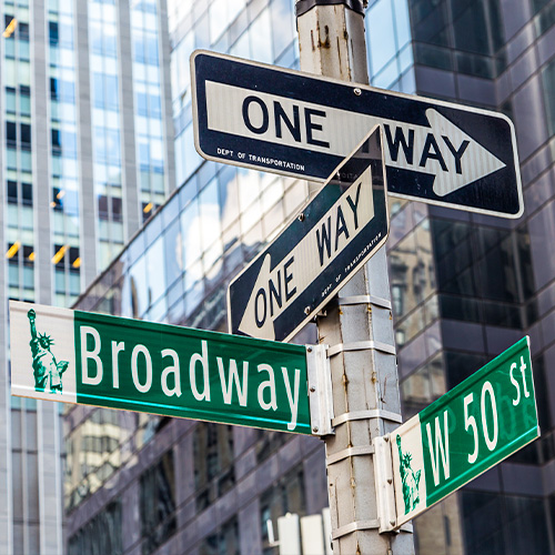 A sign post in New York pointing towards Broadway