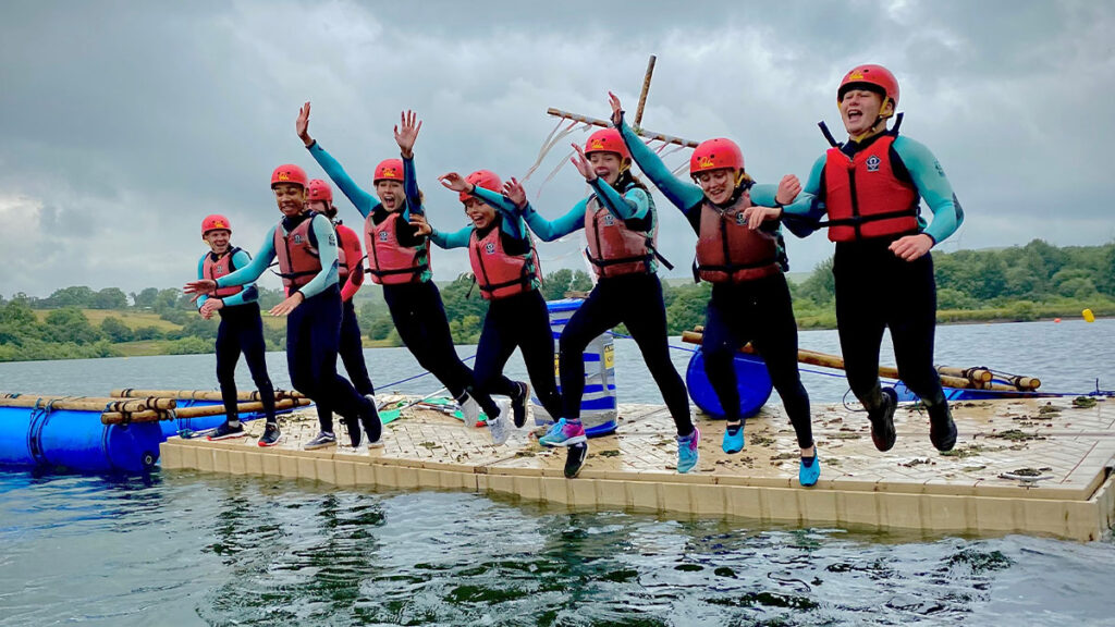 Students jumping into a lake mount cook