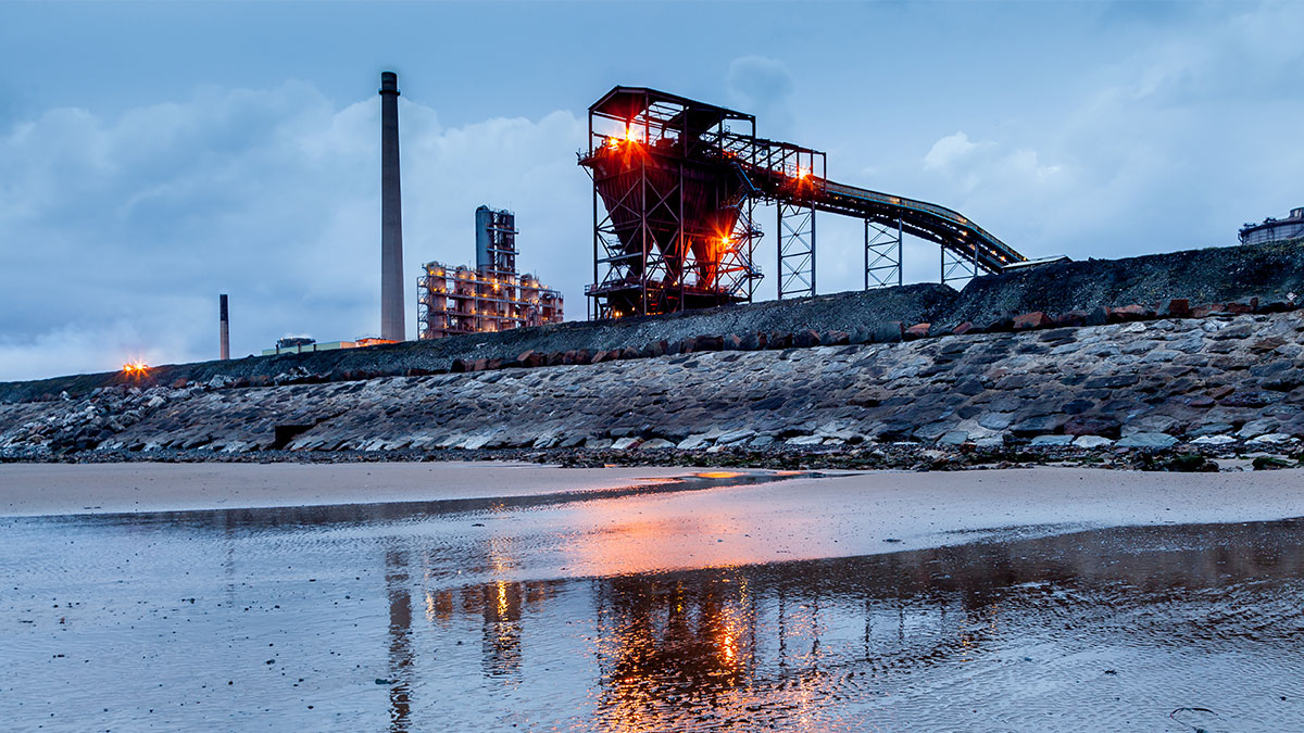 Steel Works Evening. Steel works at Port Talbot, Wales with beach in front.