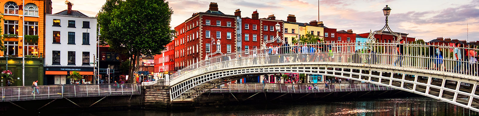 Dublin, Ireland. Night view of famous illuminated Ha Penny Bridge in Dublin, Ireland at sunset