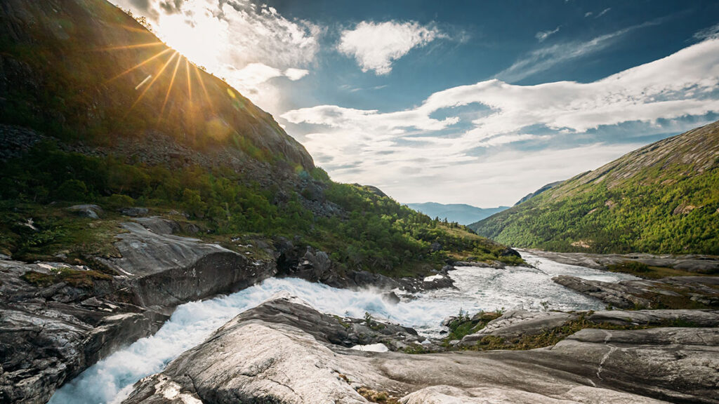 Kinsarvik, Hordaland, Norway. Water Stream Through Rocks In Hardangervidda Mountain Plateau. Sun Sunshine Above Rocky Landscape In Summer Sunny Day. Famous Norwegian Landmark And Popular Destination. Sotefossen.
