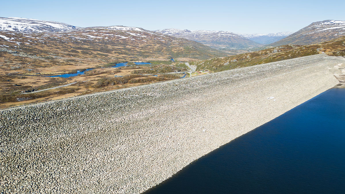 Aerial photography of the majestic Sysen Dam in Norway, surrounded by mountainous landscape and lakes, bird s-eye view.