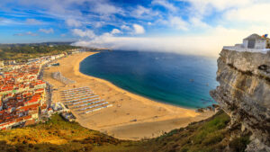 Nazare Portugal aerial. Scenic aerial view of seascape and beach waterfront from popular Miradouro do Suberco viewpoint in Nazare Sitio, the upper part of the city above the giant cliffs in Central Portugal, Europe.