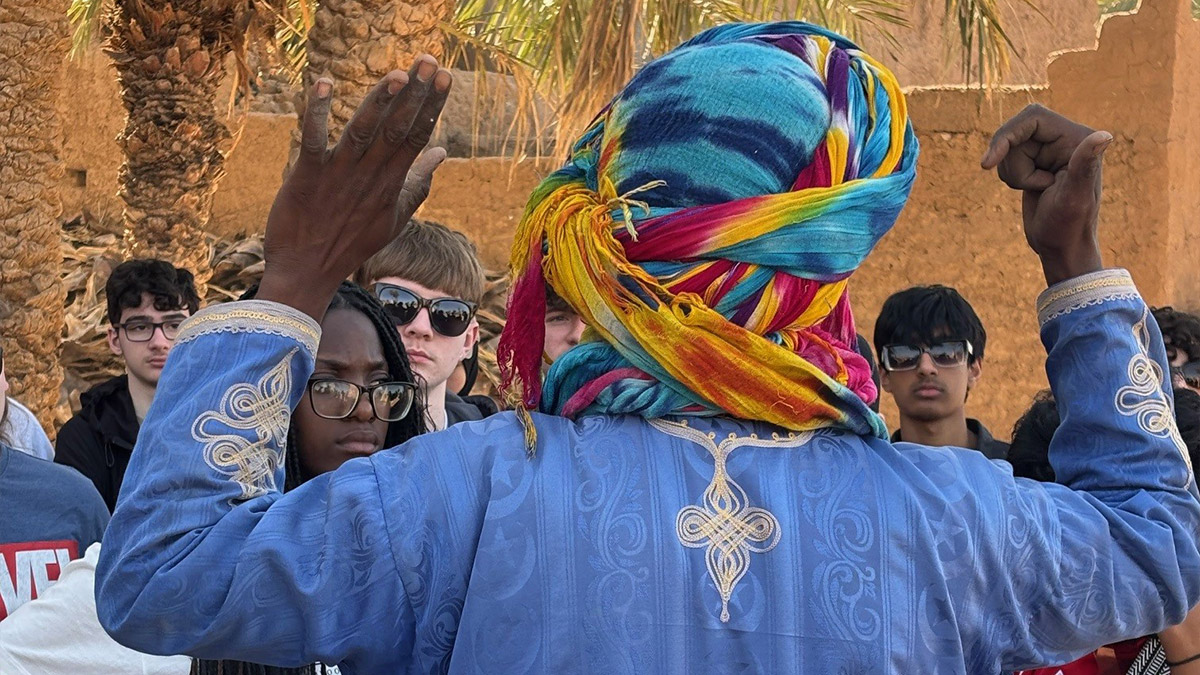 A guide in Morocco talking to british school students