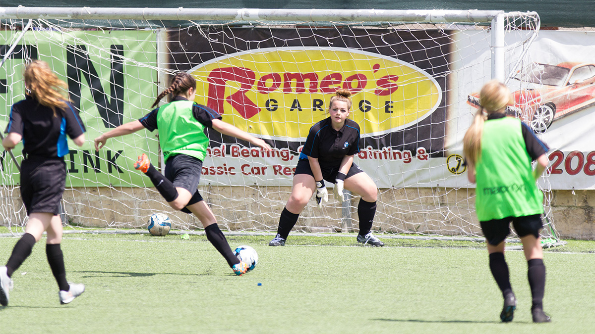 picture of girls football shooting at goal