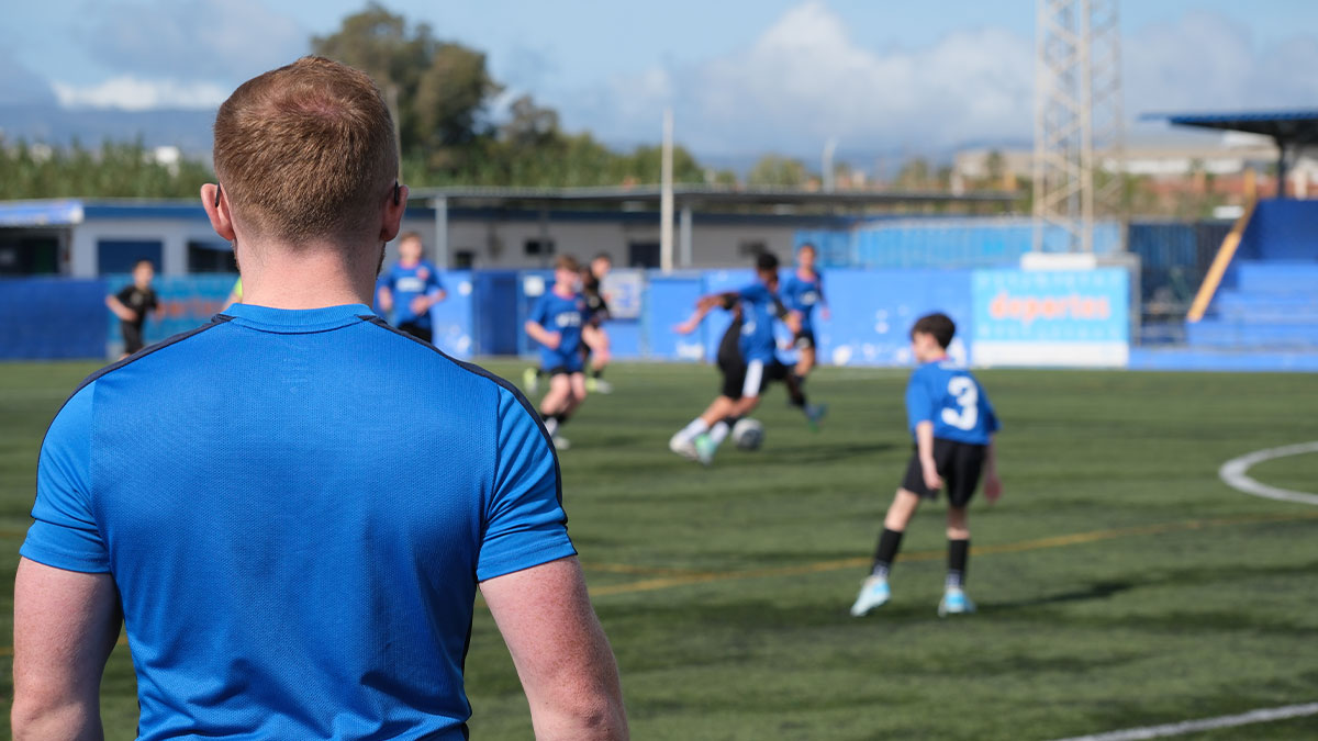 teacher watching football team while on tour in Gibraltar