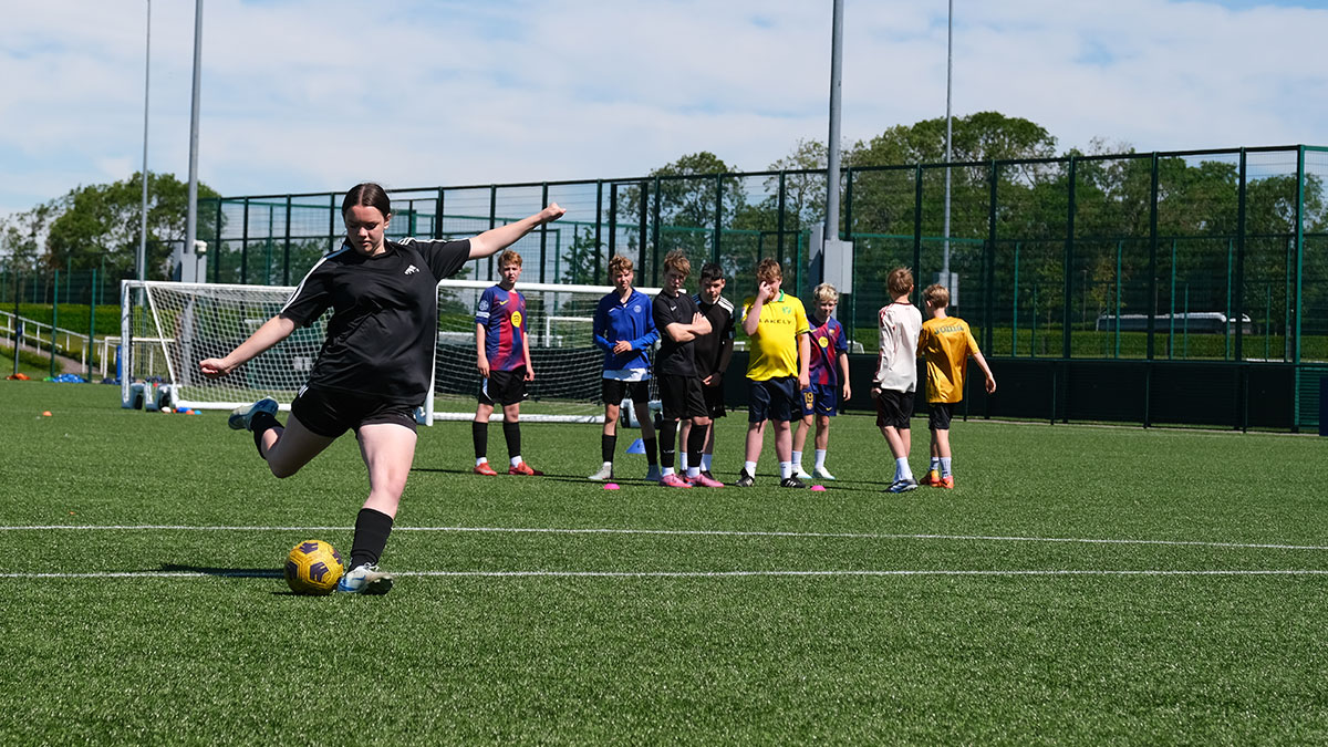 Pupil practicing free kick on a Sports Tour in the UK